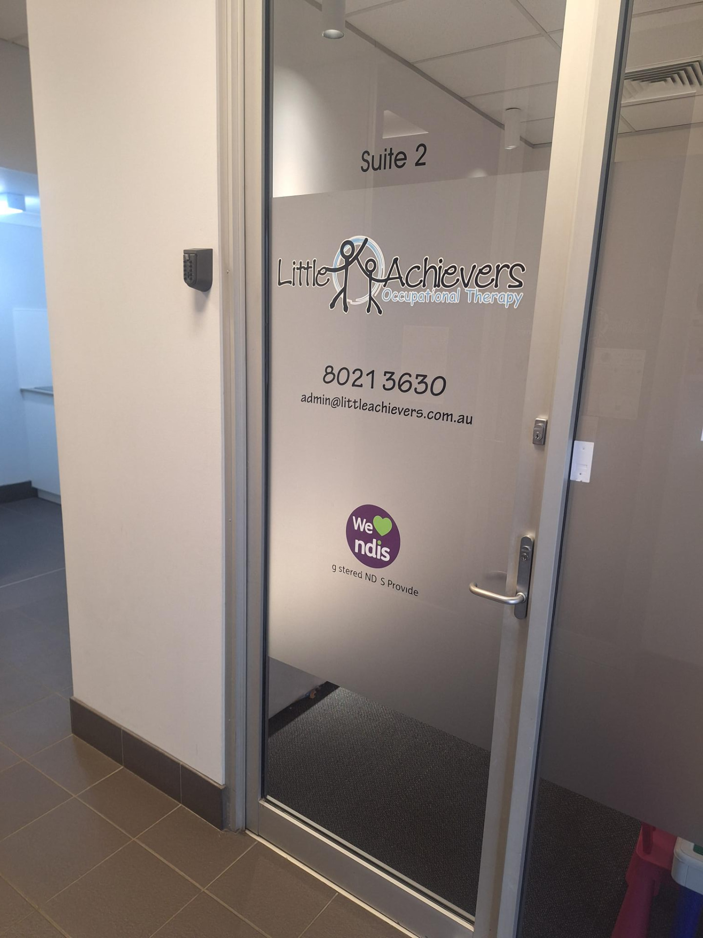 Suite 2 entry door with Little Achievers Occupational Therapy signage